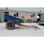 A traditional horses drawn tipping cart with painted decoration, artillery type wheels, wooden