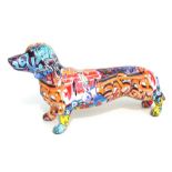 A model of a Dachshund with street art decoration, 40cms long.
