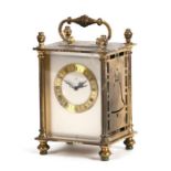 A brass cased Bucherer carriage type clock, 16cms high.