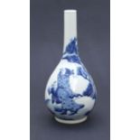 A Chinese blue and white bottle vase decorated with figures in a landscape, 25cms high.