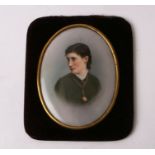 A Dresden porcelain portrait miniature of a young lady, mounted in a velvet frame, overall 10 by