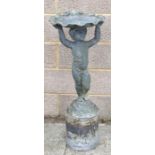A lead garden fountain in the form of a cherub holding a scallop shell, 71cms high (on a lead