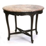 A Louis XV style mahogany centre table with oval rouge marble top above a carved frieze, on