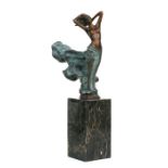 A bronze figure of an erotic scantily clad female, signed 'Milo', on a marble plinth, 32cms high