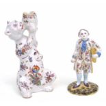 A faience candlestick in the form of a cat, 21cms high; together with a faience figure of a