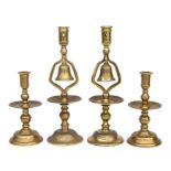 A pair of Heemskirk style brass candlesticks, 20cms high; together with a pair of brass tavern