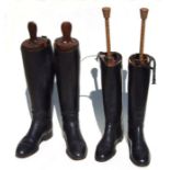 A pair of gentleman's black leather riding boots and another similar pair, both with trees (2).