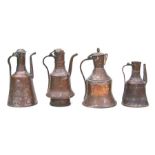 A group of Middle Eastern tinned copper coffee pots, the largest 32cms high (4).