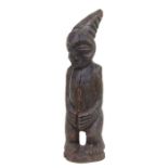 An African hardwood Yoruba carved figure with exaggerated hands and headdress, 42cms high.