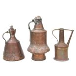 Two Middle Eastern tinned copper coffee pots, the largest 47cms high; together with a similar