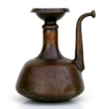 A large Islamic / Moorish copper ewer with planished surface, 34cms high.