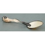 A white metal mounted seashell spoon with blank shield shaped cartouche and red stone set cabochon