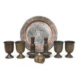 A group of Middle Eastern metal ware to include goblets, candlesticks and tray.