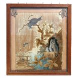 A 19th century silkwork embroidered panel depicting owls and owlets in a landscape, framed & glazed,