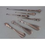 Six Victorian silver handled button hooks and shoe horns, various dates and makers.