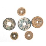 A group of Chinese coins or pierced discs decorated with calligraphy, the largest 4cms diameter (