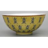 A Chinese footed bowl decorated with longevity or shou characters on an Imperial yellow ground,