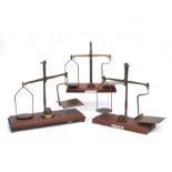 A De Grave & Co. brass and mahogany GPO balance scales and, 33cms wide; together with two similar (