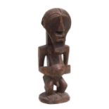 African Art / Tribal Art: a carved wooden Songye male figure, 38cms high.