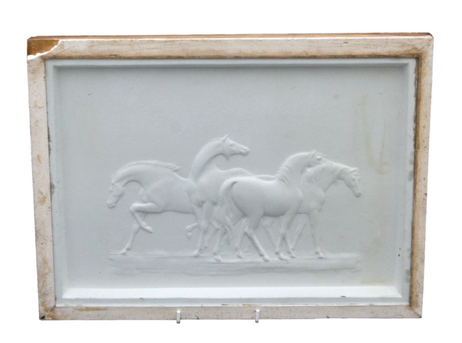 An early 20th century relief moulded plaster panel depicting a group of horses, indistinct