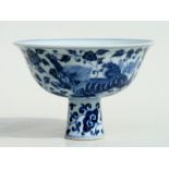 A Chinese blue & white stem cup decorated with shishi amongst scrolling foliage, with six