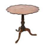 An early 19th century mahogany pie crust tilt-top table on turned column and tripod base, 73cms