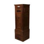 An early 20th century walnut country house private posting box with hinged panelled door with single