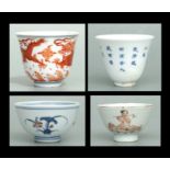 A Chinese blue, white and red tea bowl decorated with flowers, six character mark to the