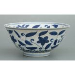 A Chinese blue & white footed bowl decorated with scrolling flowering foliage, six character blue