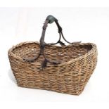 A woven wicker basket with metal and glass handles, 60cms wide.