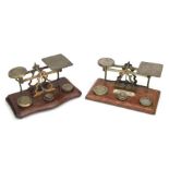 A set of late 19th / early 20th century South African brass postal scales and weights on a shaped