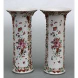 A pair of Chinese famille rose fluted sleeve vases with moulded decoration depicting flowers and