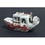 A Chinese pottery water dropper in the form of a boat, decorated in underglaze red, 15cms long.