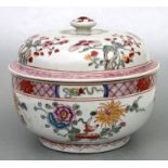 A Chinese famille rose bowl and cover decorated with flowers, six character red mark to the