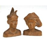 A pair of Malaysian carved wooden busts of a lady and gentleman in traditional head dress, both