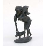 African / Tribal Art: A carved African hardwood group depicting a bushman carrying his kill back