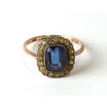 A 9ct gold dress ring with central blue stone, approx UK size 'O'.