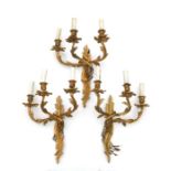Three rococo style triple-arm gilt bronze wall lights, 48cms high (3).
