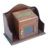 A Victorian oak table top letters box with inset brass letters slot above a glazed door, 32cms