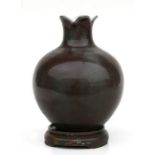 A Chinese monochrome vase of globular form, on a hardwood stand, 14cms high.Condition ReportSome