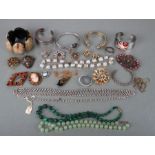 A quantity of costume jewellery to include an agate set forget-me-not cameo brooch; together with