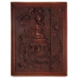 A 19th century carved wooden panel depicting a cherub and scrolling flowering foliage, framed, 26 by