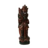 A large Balinese polychrome carved wooden figure, 112cms high.