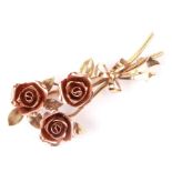 A 14ct rose gold and yellow gold brooch in the form of a spray of roses, 6cms long, 12.7g.