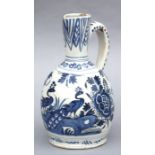 A 19th century Delft blue & white jug decorated with peacocks and flowers, 23cms high.