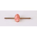 A 14ct gold carved coral cameo bar brooch, 5cms wide.