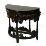 An 18th century style carved oak demi-lune Credence table with fold-over top, 73cms wide.