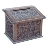 A Victorian carved oak country house table top letters box with sloped top and letters slot and