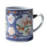 A Chinese famille rose oversized cider tankard decorated with figures in a landscape, 14cms high.