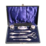 An early 20th century 8-piece manicure set with silver topped jars and handles, Chester 1920,